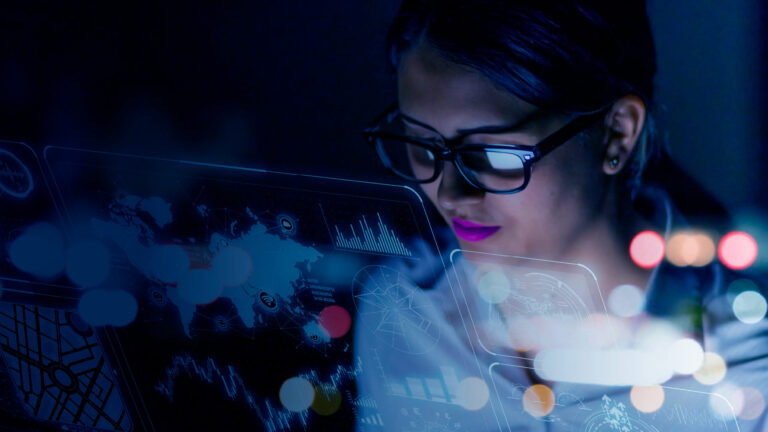 Data engineers collaborating around a high-resolution analytics dashboard